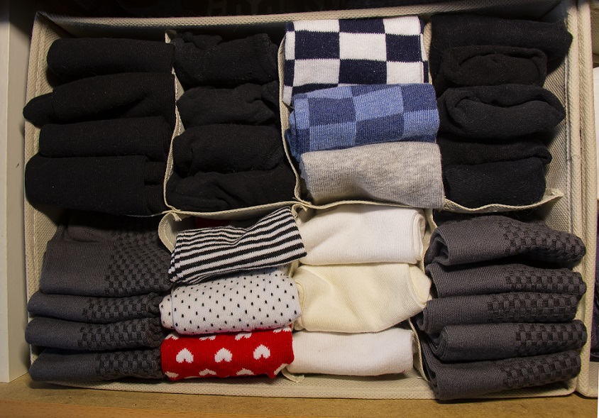 how to organize your bedroom by folding clothes or rolling towels